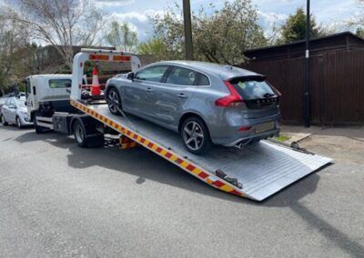A car is being towed by a tow truck.
