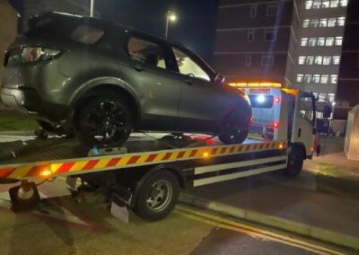 A car is being towed by a tow truck.