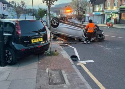 A car has crashed into another car on the side of the road.