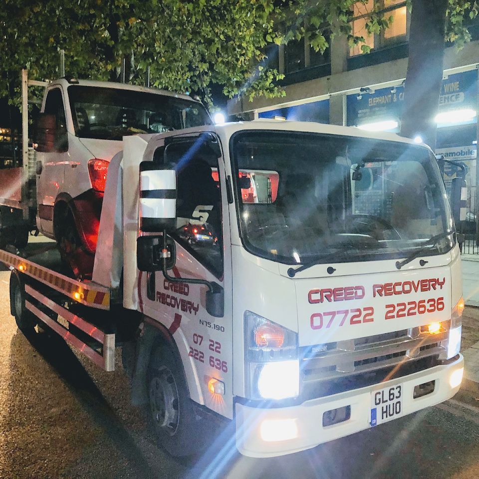 A tow truck that says creed recovery on it