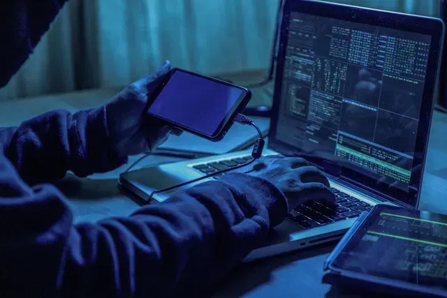 A Person Is Holding A Cell Phone In Front Of A Laptop Computer — Pleasanton, CA — Thompson • Garcia Law