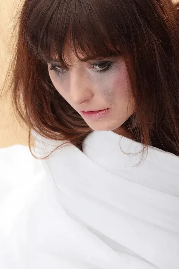 A Close Up Of A Woman Wrapped In A White Cloth — Pleasanton, CA — Thompson • Garcia Law