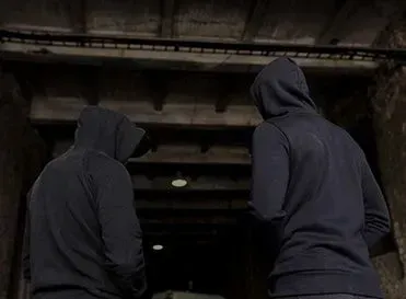 Two Men In Hoodies Are Standing Next To Each Other In A Dark Room — Pleasanton, CA — Thompson • Garcia Law