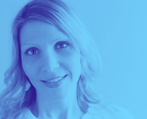 A close up of a woman 's face with a blue background.