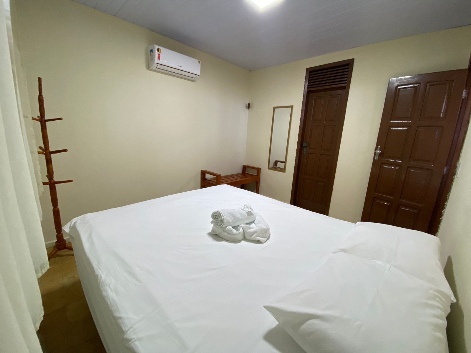 Há uma cama grande no meio do quarto.