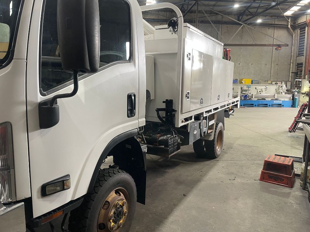 A White Truck Is Parked In A Warehouse — McLaren Engineering in Atherton, QLD