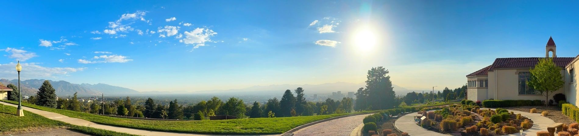 Nighttime photo of a modern building with large windows, illuminated by exterior lights.