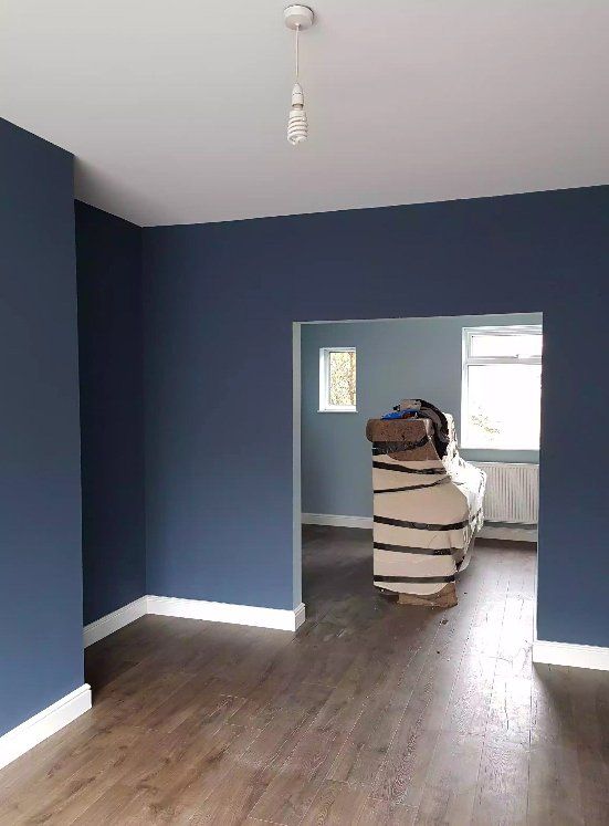 Freshly painted room with navy walls.