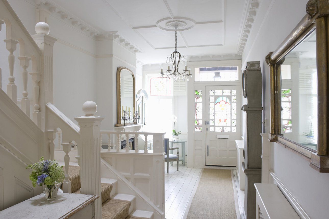 Bright hallway with modern staircase, wooden flooring, and natural light streaming in York.