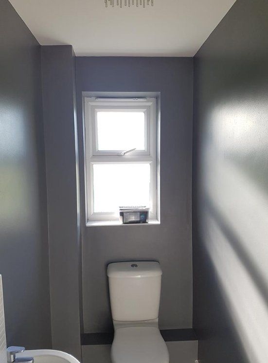 Renovated hallway featuring a small window with clean white walls in York.