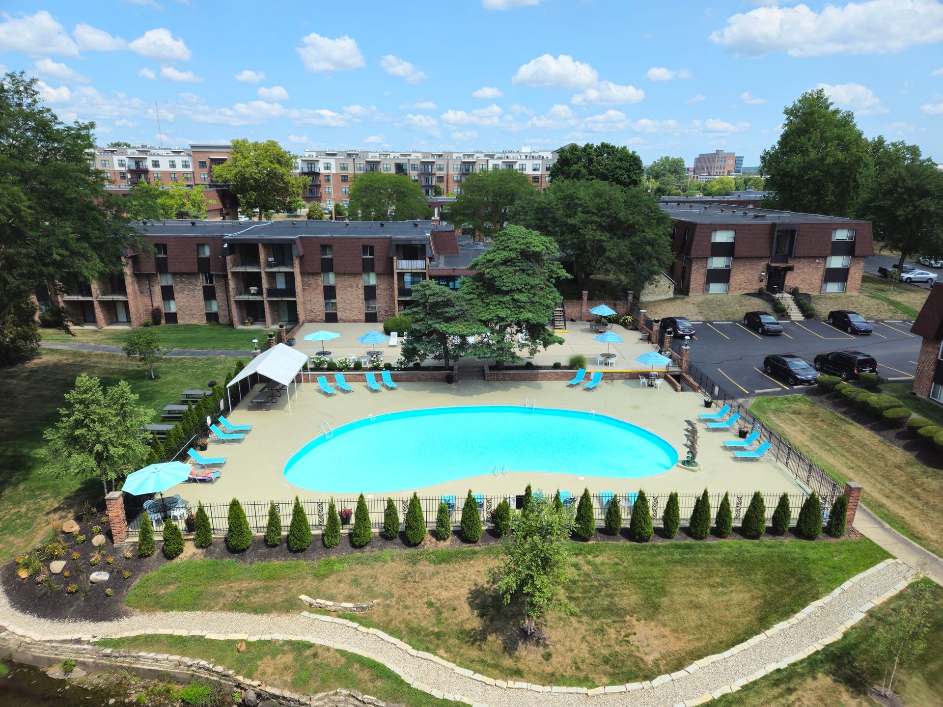 An aerial view of a large swimming pool in front of a building.
