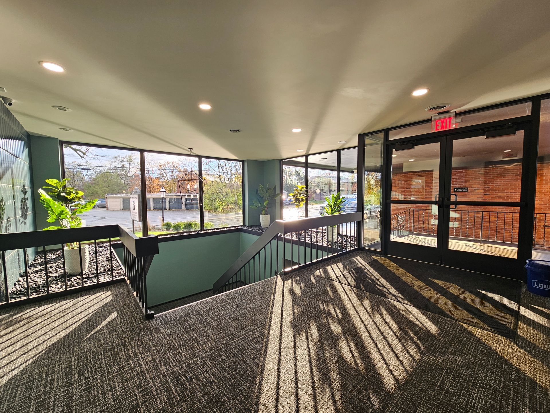 A hallway with stairs leading up to the second floor of a building.