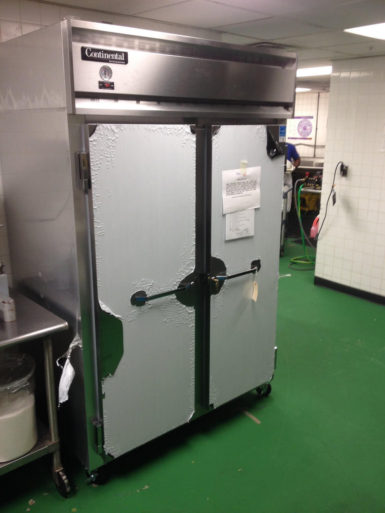 A large stainless steel refrigerator is sitting in a kitchen.