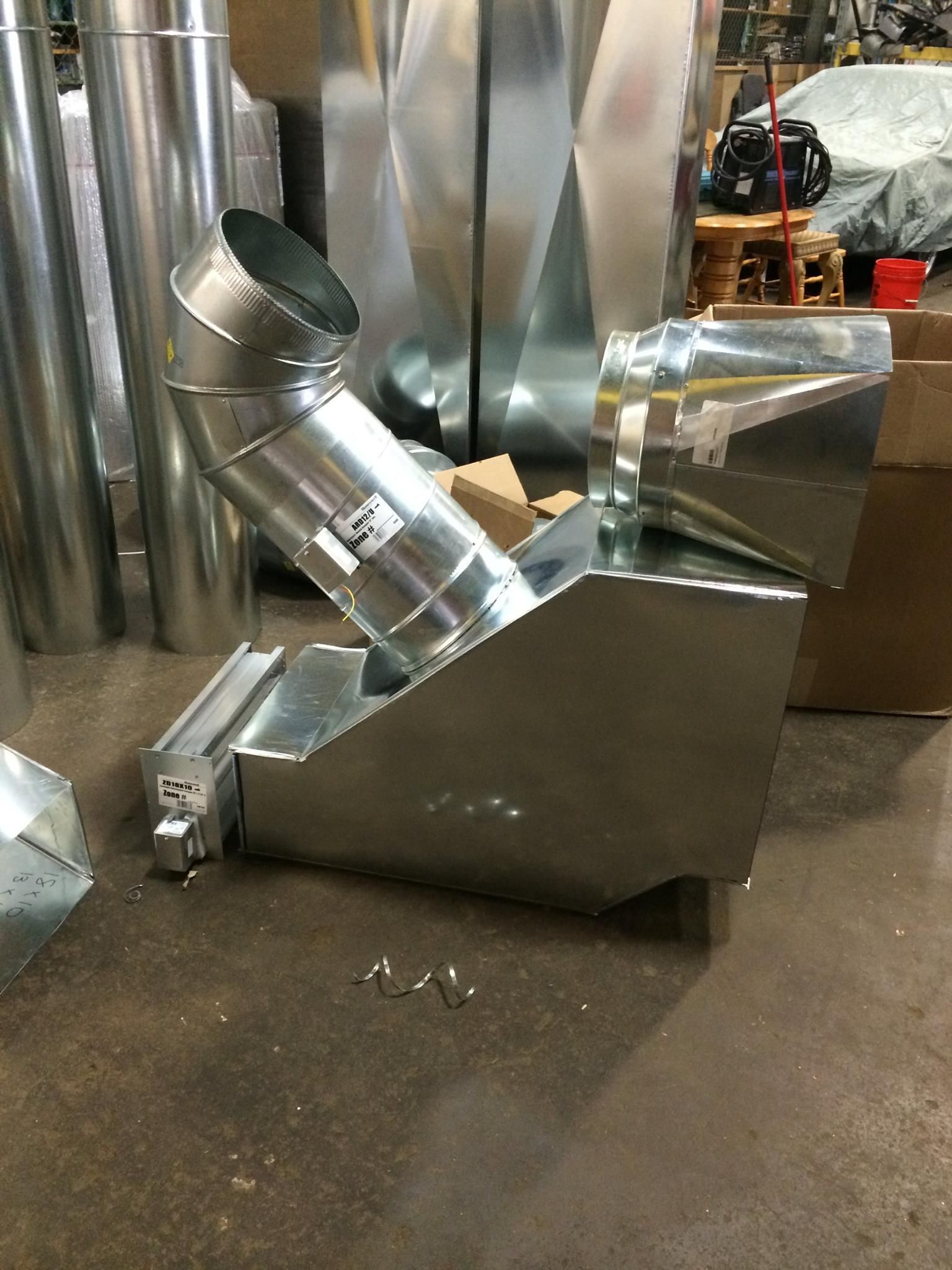 A man is welding a piece of metal in a factory.