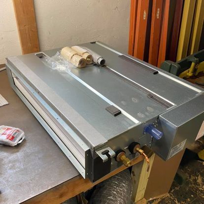 A machine is sitting on top of a wooden table.