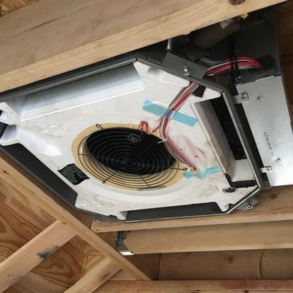 A fan is hanging from the ceiling of a building.