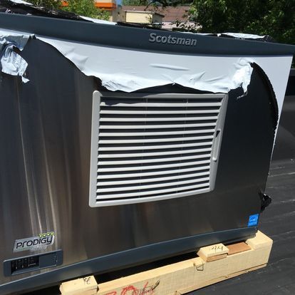 A scotsman appliance is sitting on a wooden pallet