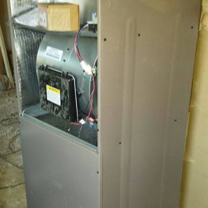 The inside of a refrigerator with the door open and a fan.