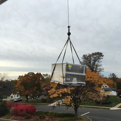 A large box is being lifted by a crane.
