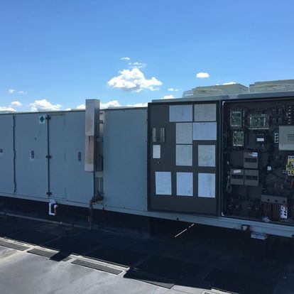 A large gray building with a blue sky in the background.