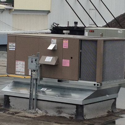 An air conditioner is sitting on the roof of a building