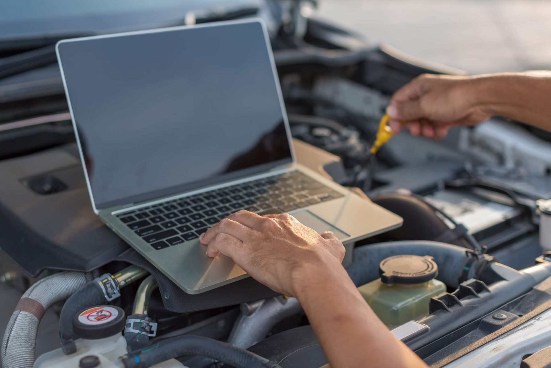 The mechanic is checking the car condition in the car service center. The mechanic is checking the car condition in the car service center.