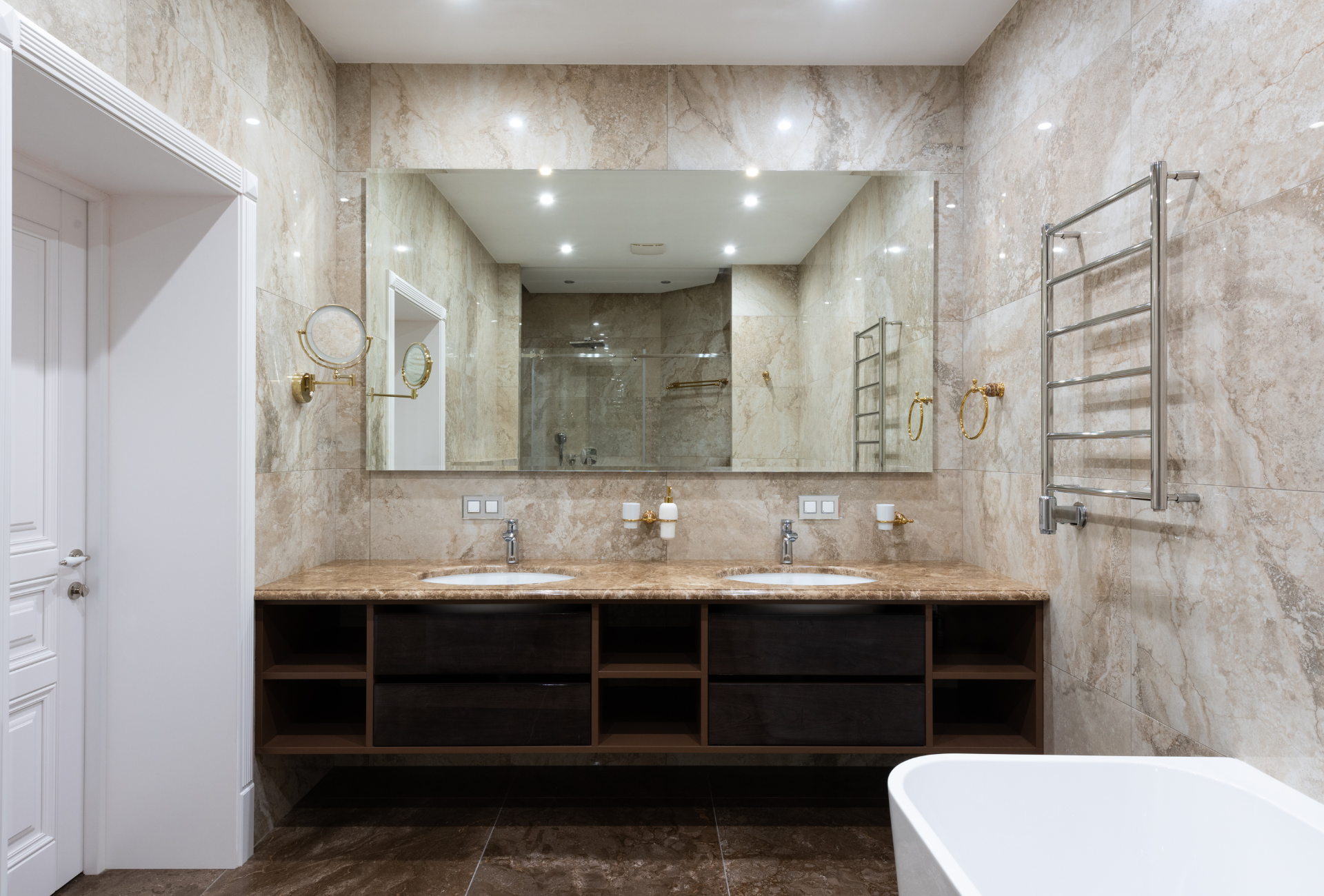 A bathroom with two sinks and a large mirror.