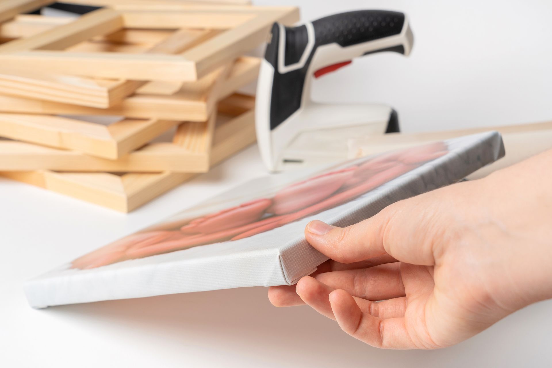 Man and woman examining a sheet on a large printing machine in a workshop