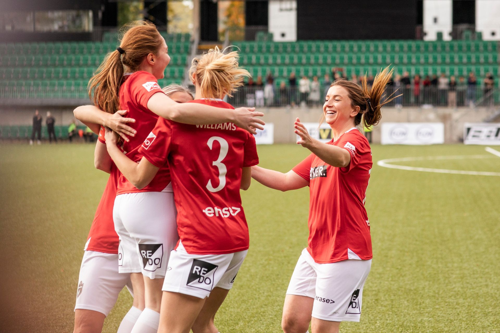 Man using yellow heat press to apply design to a dark gray t-shirt on a table.