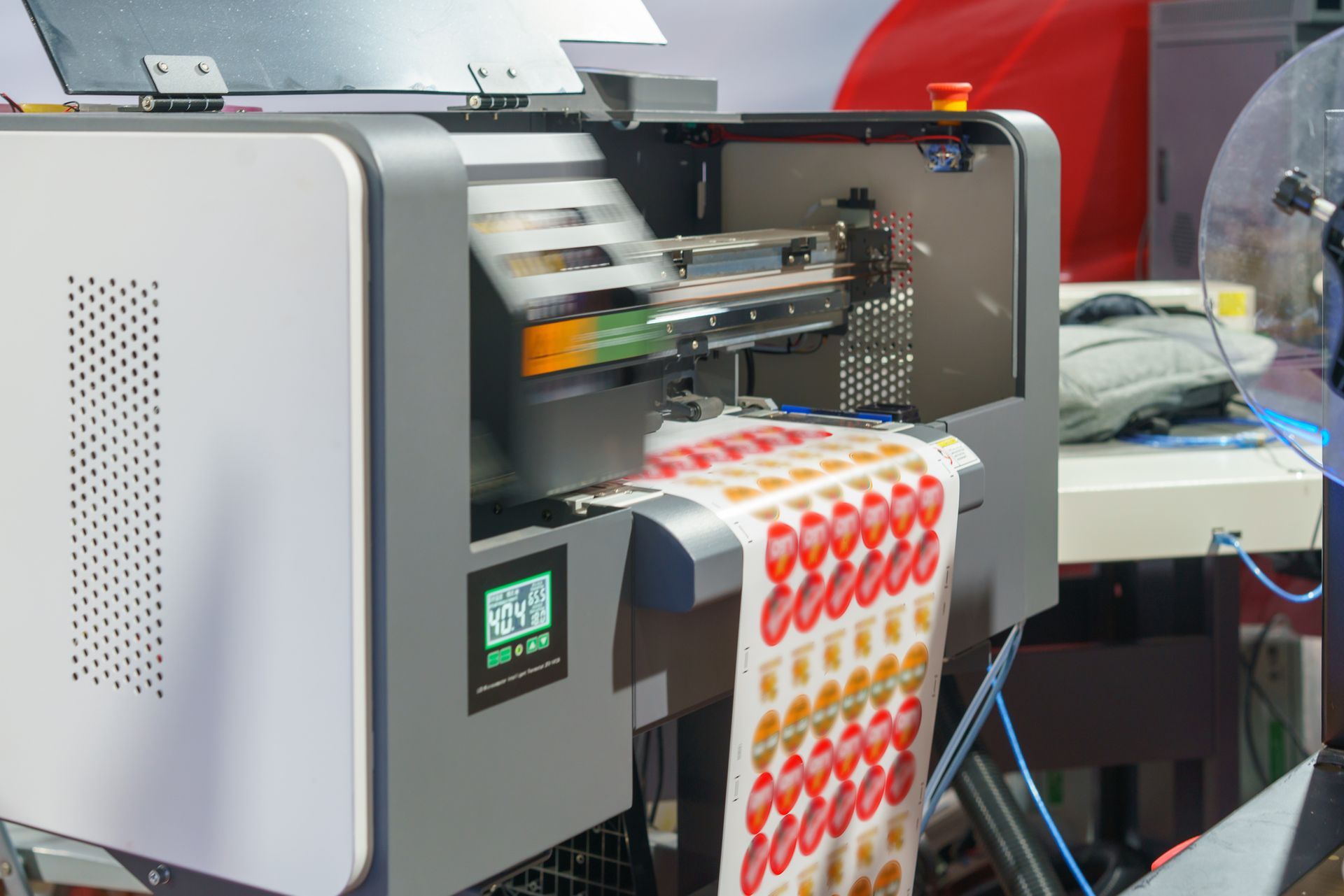 Digital label printer in operation, printing colorful fruit stickers on a roll of paper.