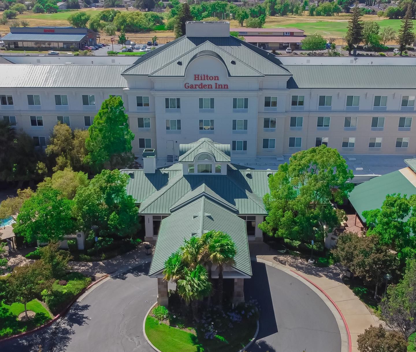 An aerial view of a hotel with a green roof