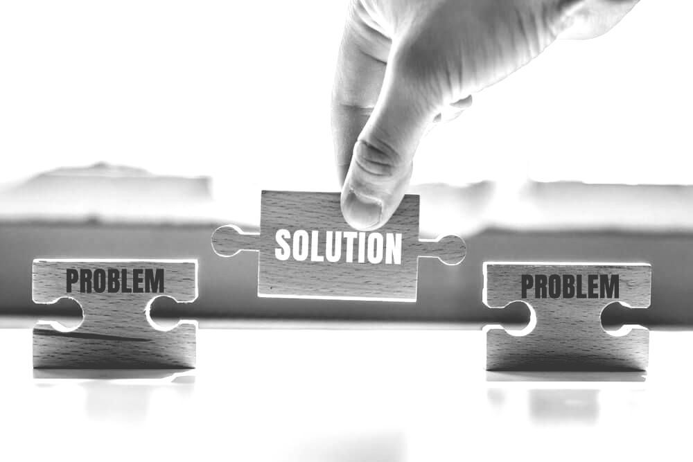 Hand Holding A Wood Puzzle With Word — Farrell Lusher Solicitors In Wagga Wagga, NSW