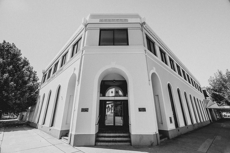 Black and White Photo of a Building With A Mirrored Door — Farrell Lusher Solicitors In Wagga Wagga, NSW