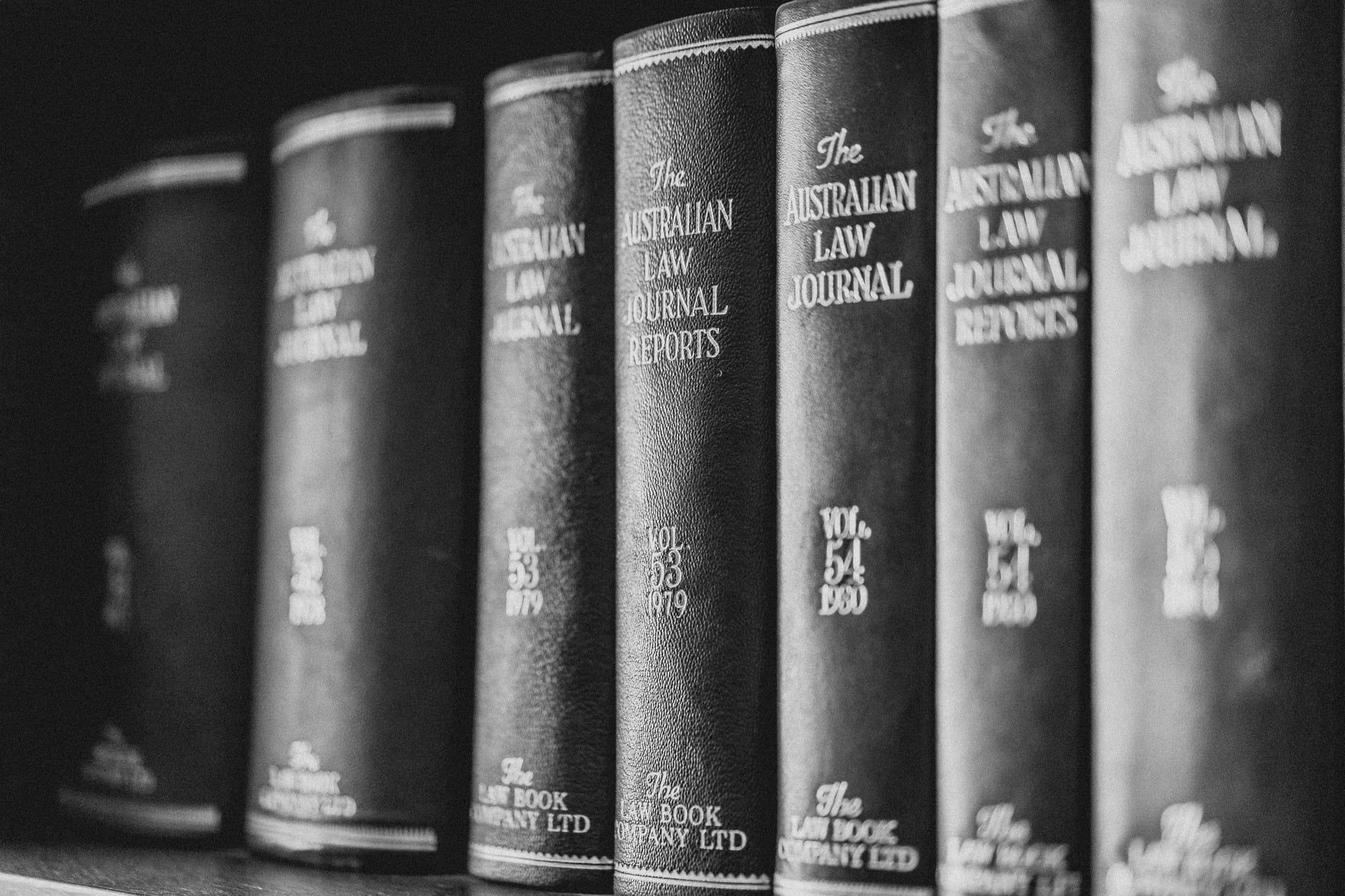 A Gavel Besides A Judge Holding A Pen And A Justice Scale — Commercial Law in Wagga Wagga