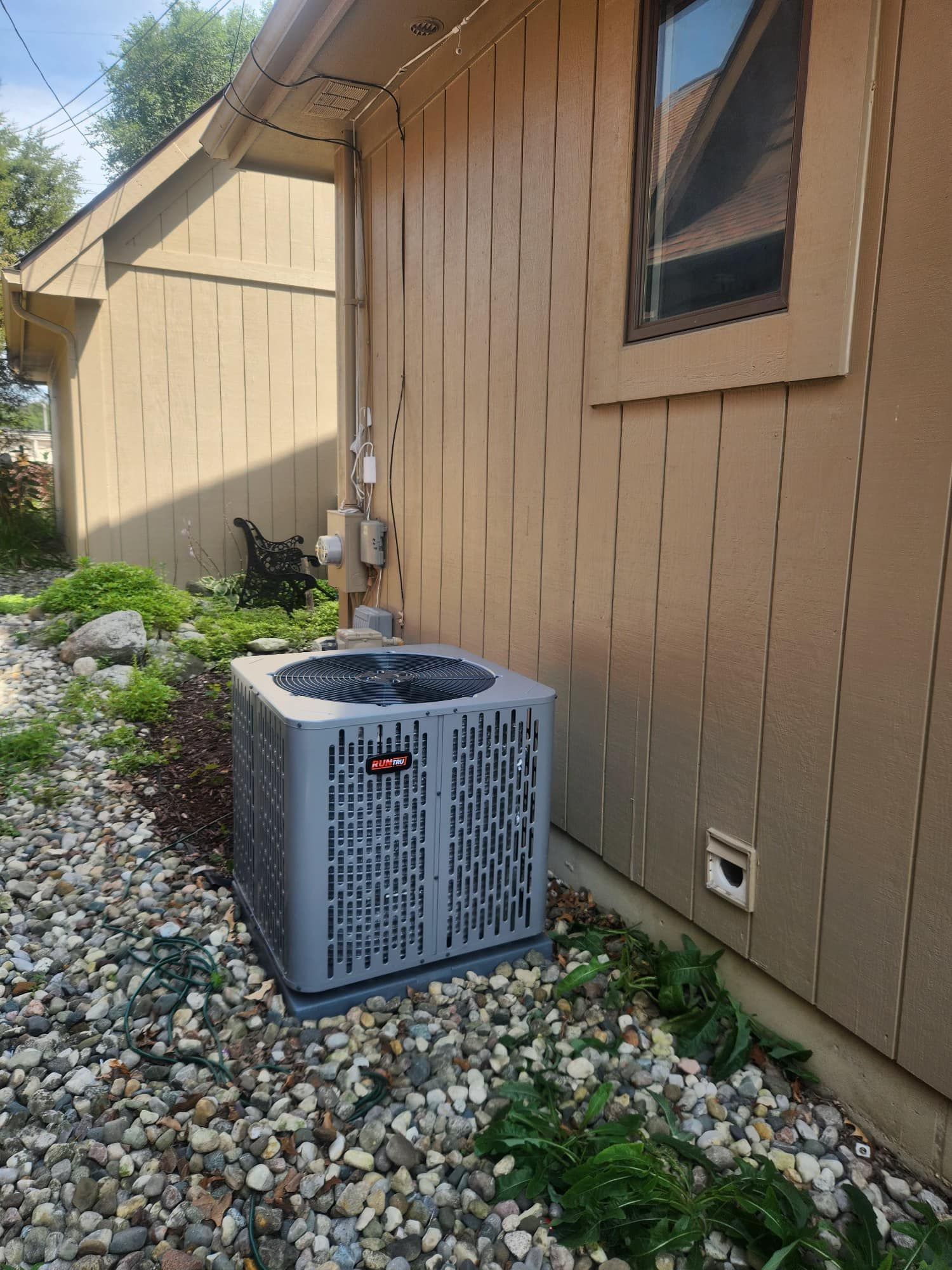 A wooden fence is sitting on top of a lush green field.