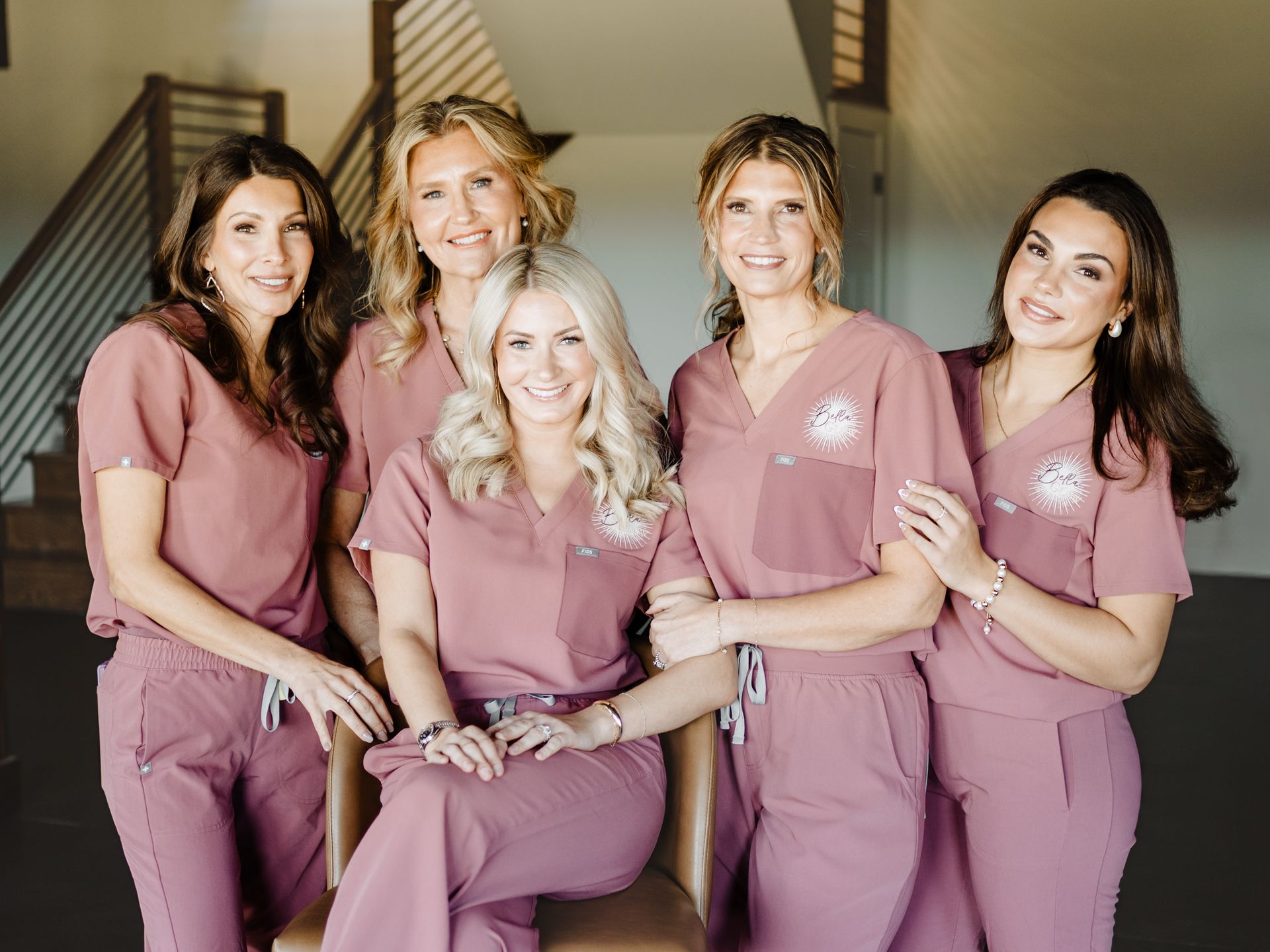 A neon sign that says `` you glow girl '' is hanging on a wall next to a mirror.