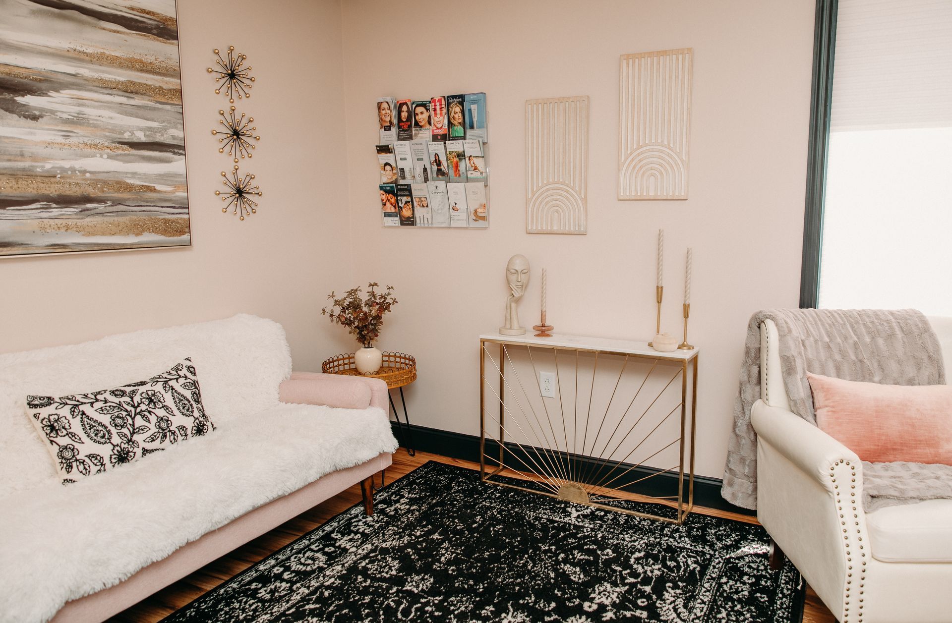 A living room with a couch , chair , table and rug.
