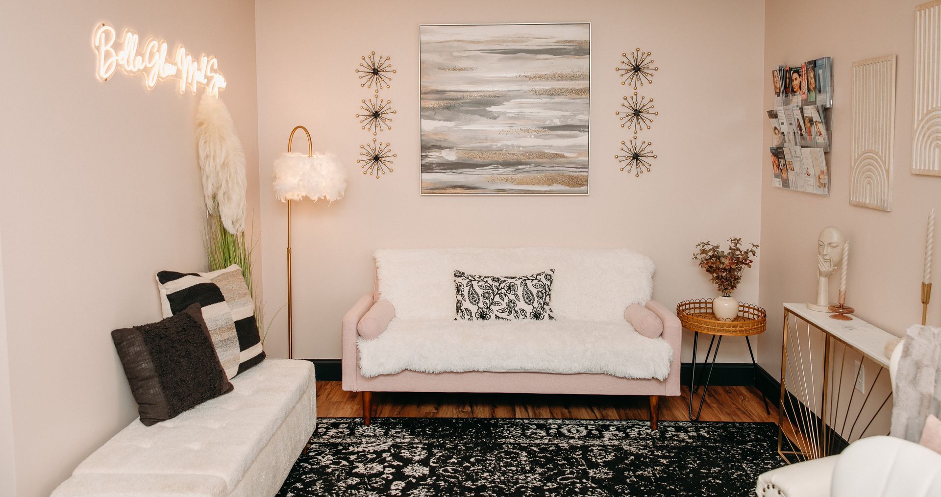 A living room with a couch , chairs , and a rug.