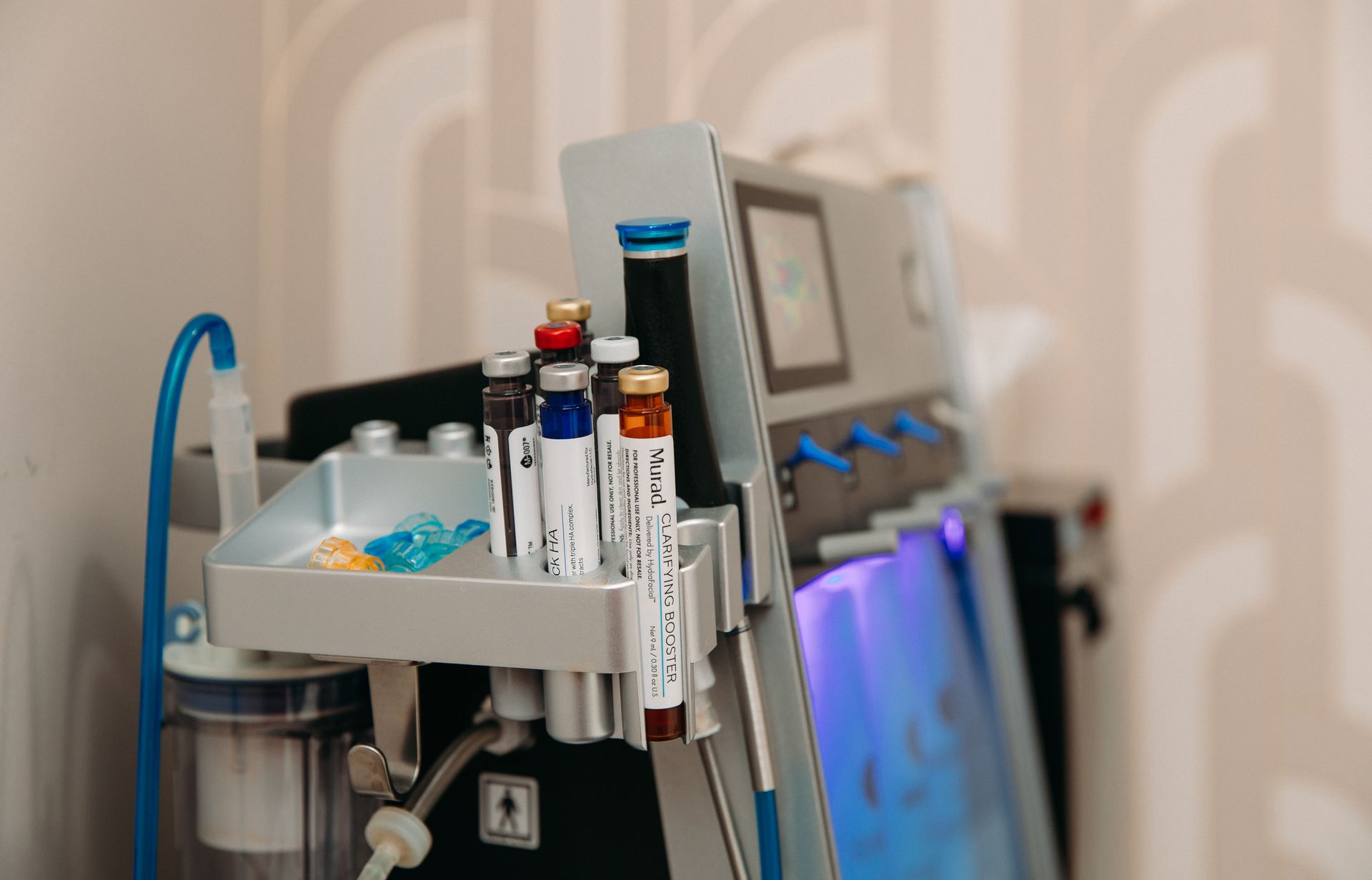 A close up of a machine with a tray of bottles on it.