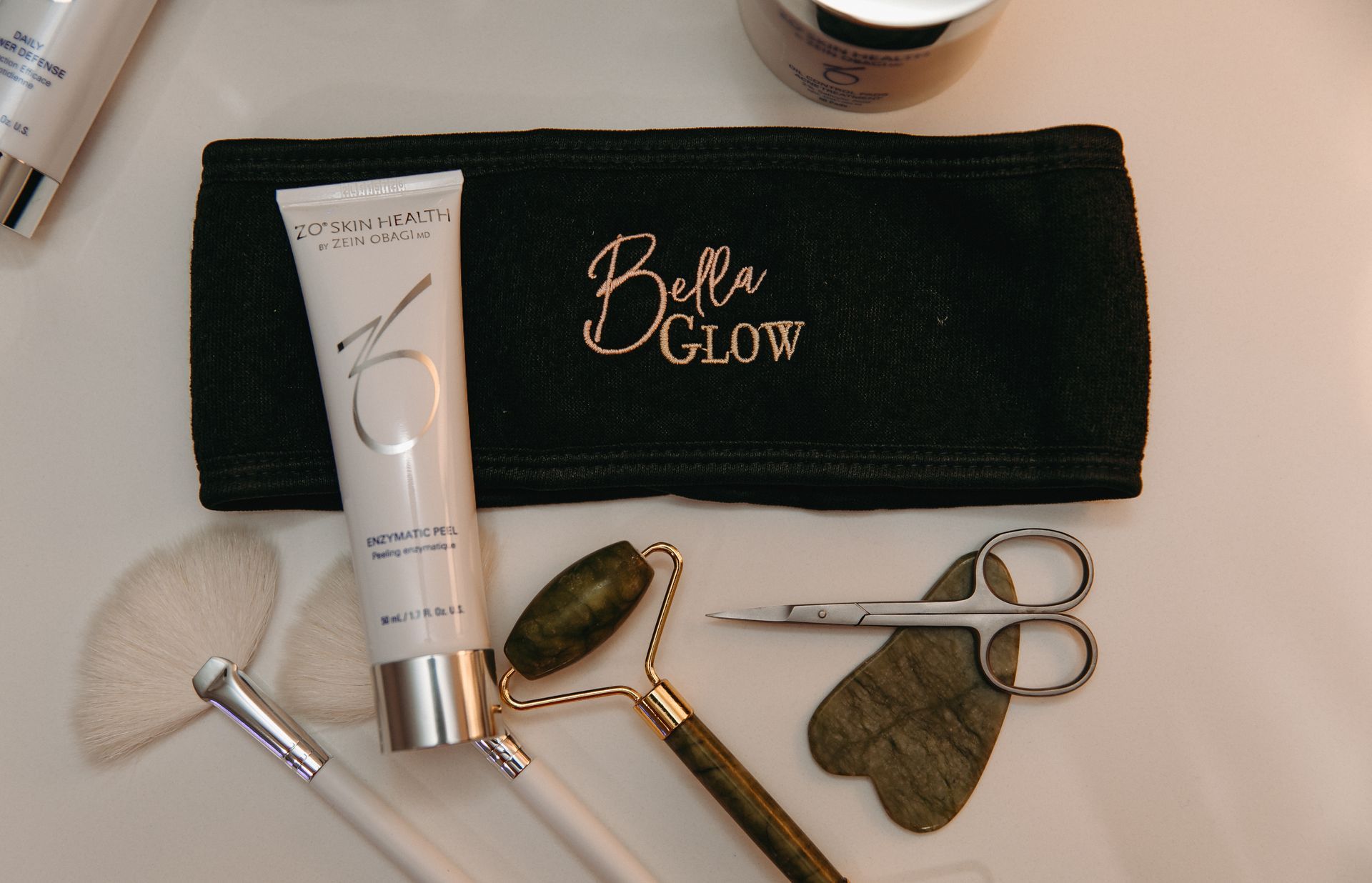 A black headband with bella glow written on it