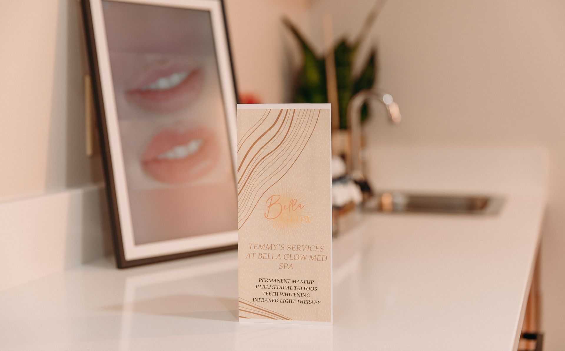 A brochure is sitting on a counter next to a picture of a woman 's lips.