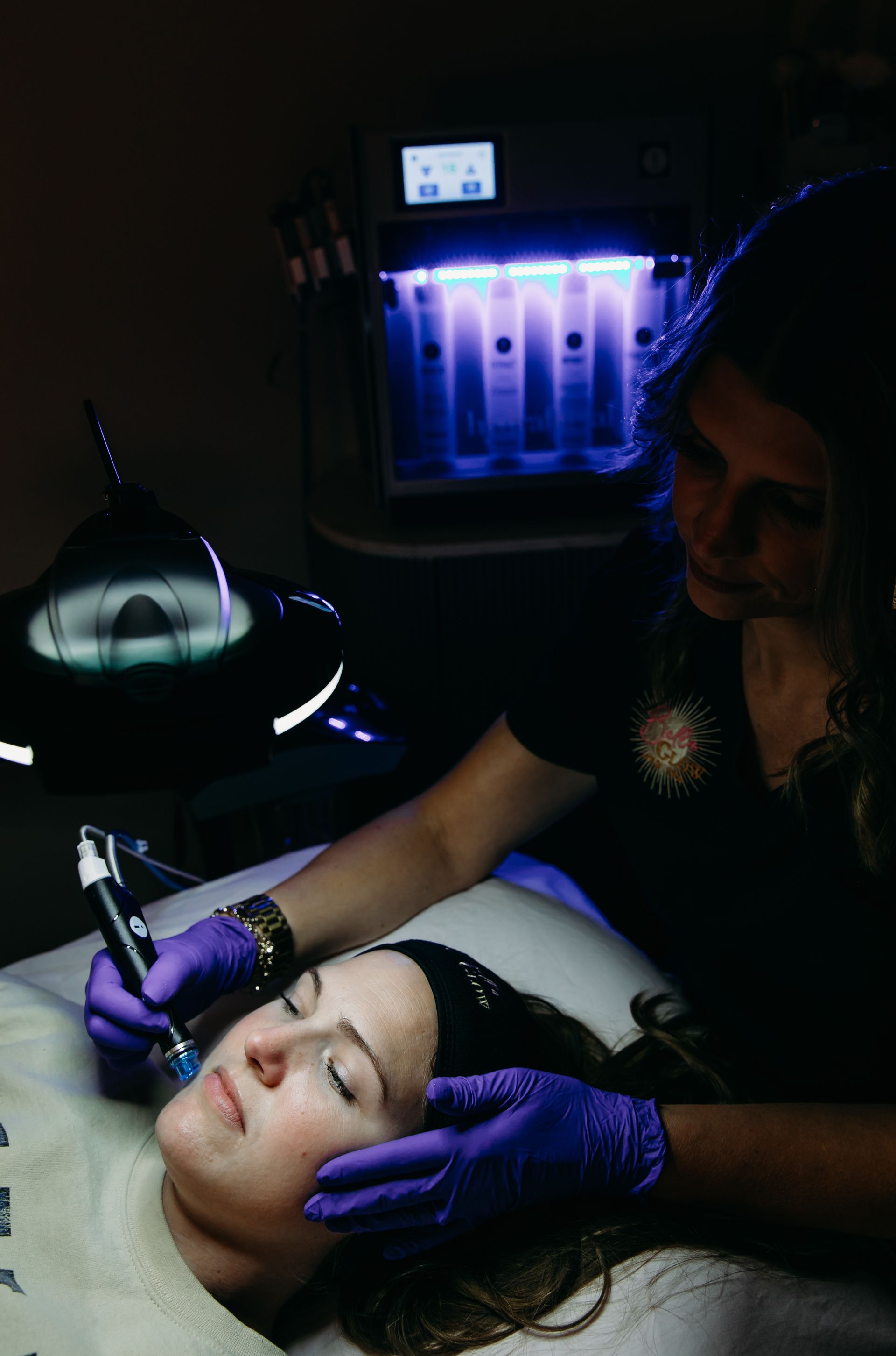 A woman is getting a facial treatment at a beauty salon.