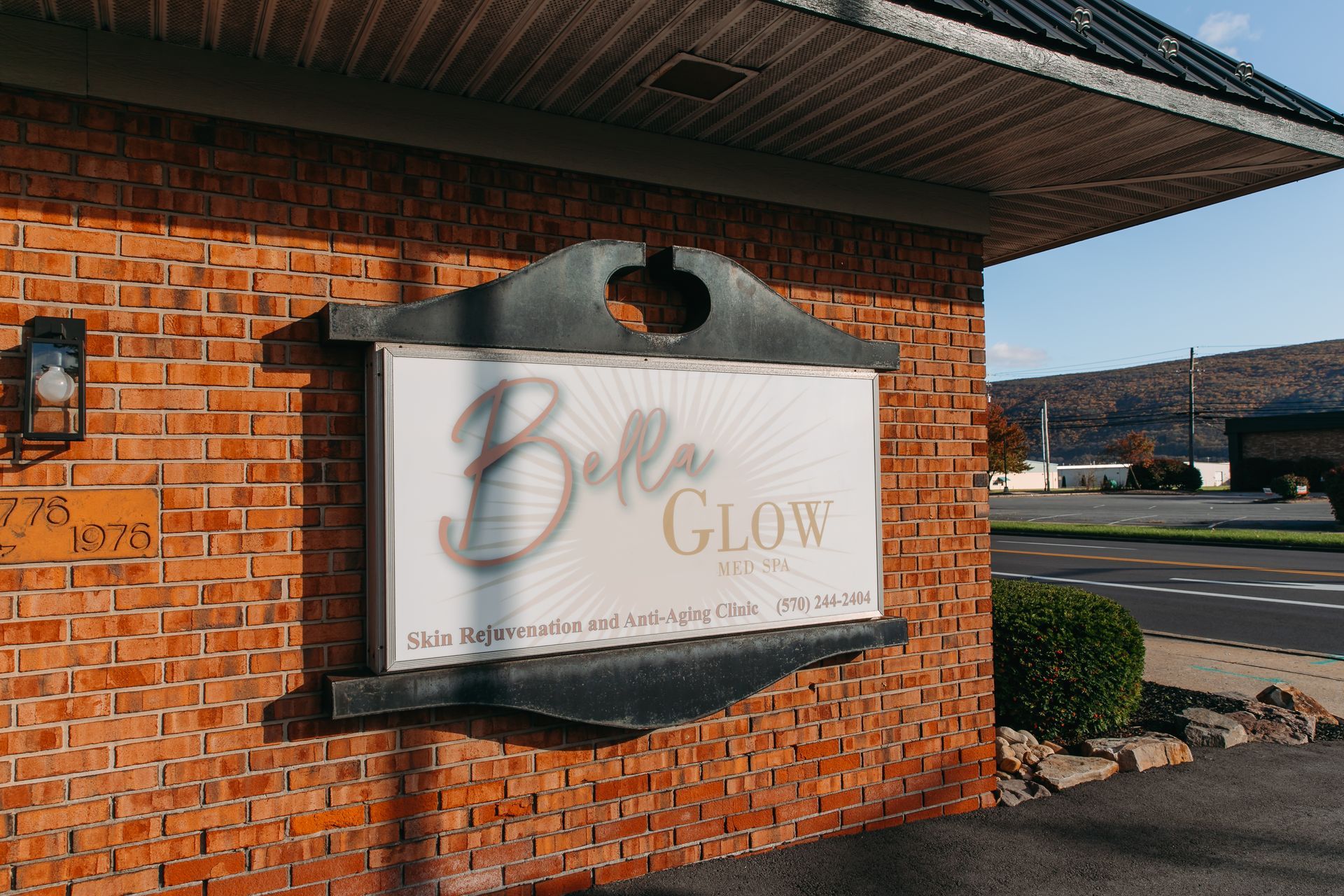 A brick building with a sign that says bella glow on it.