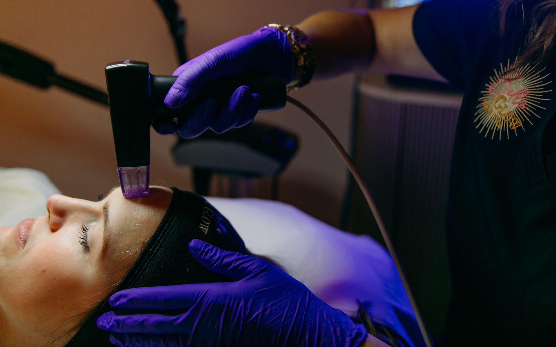 A woman is getting a facial treatment at a beauty salon.
