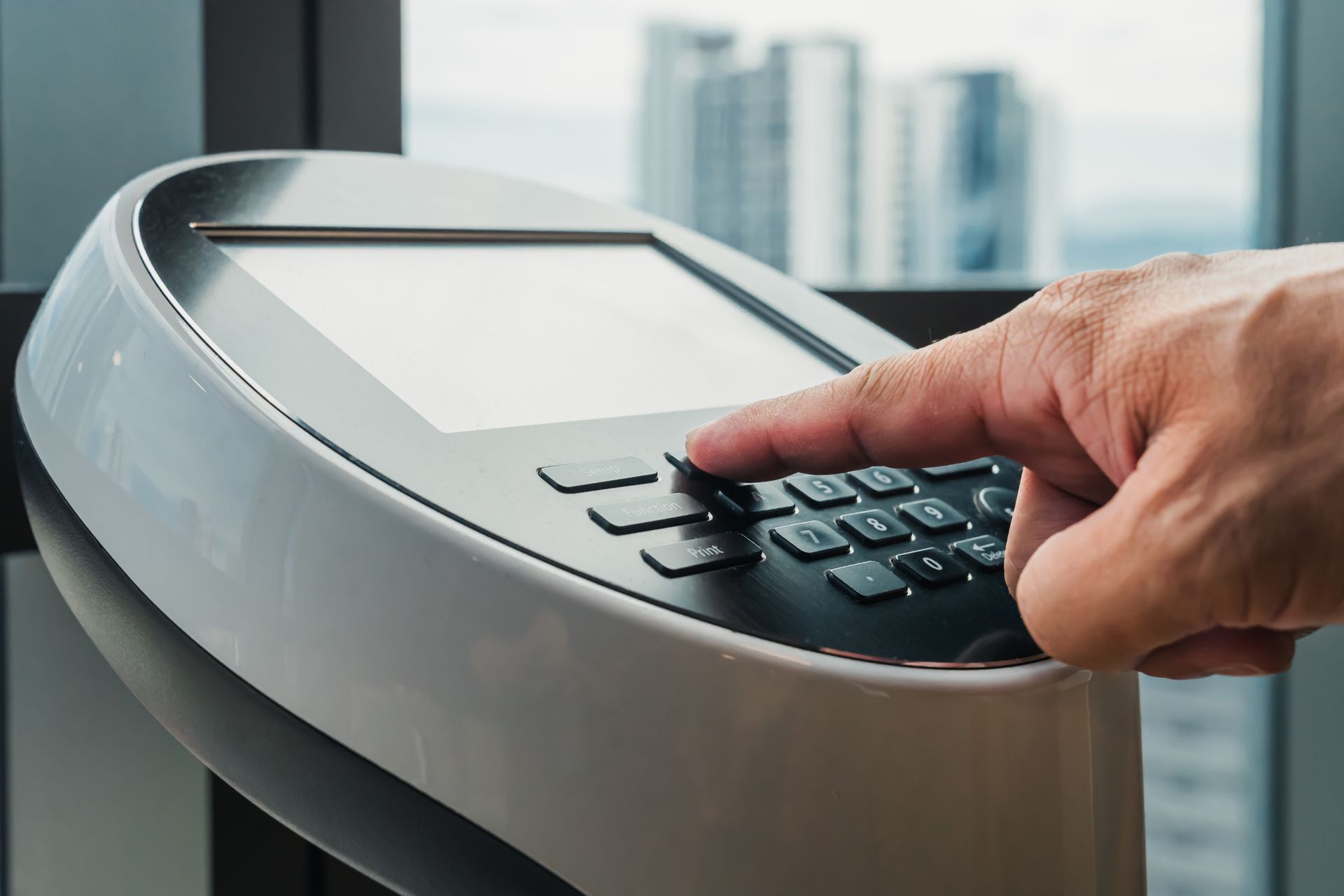 A person is pressing a button on a machine.