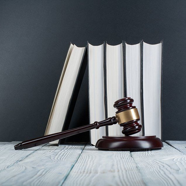 wills and estates lawyer burlington and hamilton Judges Gavel in front of books on a wooden white table