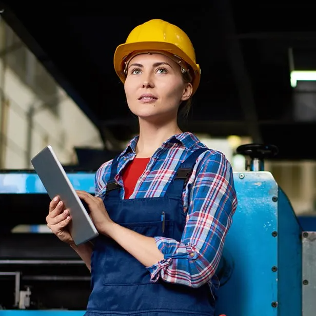 Girl wearing yellow hard hat holding ipad