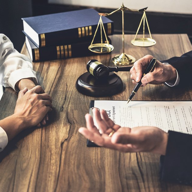 employment lawyer Hamilton Laywer presenting contract to client on brown wooden table