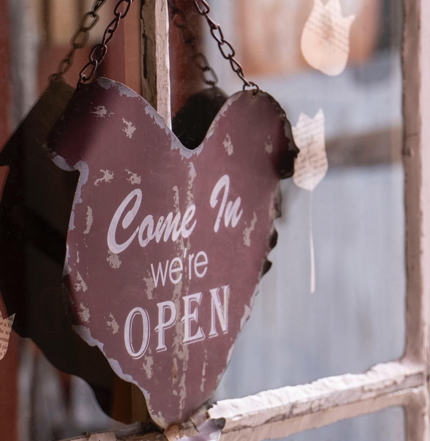 A door with a heart on it that says come in we're open