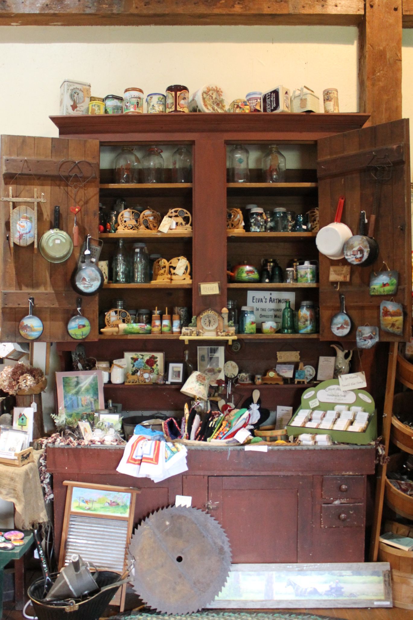 A room filled with lots of antique items including a saw blade